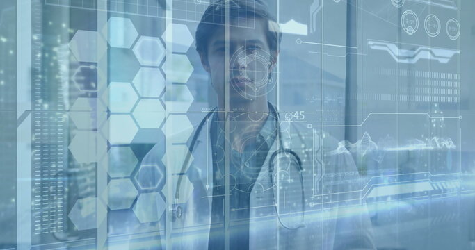 Facing male doctor wearing lab coat and stethoscope in clinic interacting with holographic diagrams