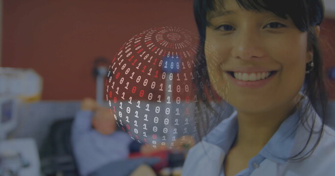 Smiling woman wearing light blue shirt in cubicles, with hovering binary sphere above monitors - Powered by Adobe