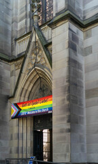 A rainbow flag on a church in Basel, with the inscription in German: "God is love" and an invitation to members of the LGBTQ+ community. 