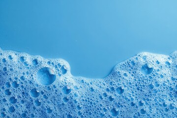 A vibrant blue surface with soapy foam