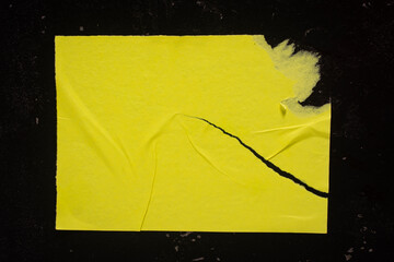 Yellow torn poster close up.