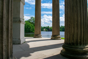 Classical Pillars Framing Scenic Summer Lake View