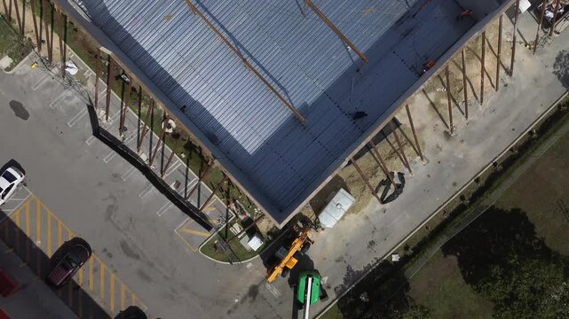 Aerial view of building construction using precast concrete wall panels with steel support columns and metal roof