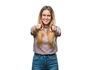 Smiling young woman with blonde hair gesturing with thumbs up gesture of approval transparent background