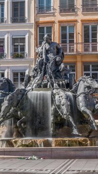 Hyperlapse of the Bartholdi Fountain, a symbol of Lyon, located on Place des Terreaux near City Hall. Equestrian sculpture with flowing water, surrounded by historic architecture timelapse. France