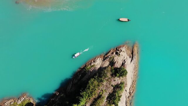 Lala Khal, Bangladesh - 22 August 2025: Aerial view of boats sailing on turquoise waters contrasted against the lush greenery of the riverbanks.