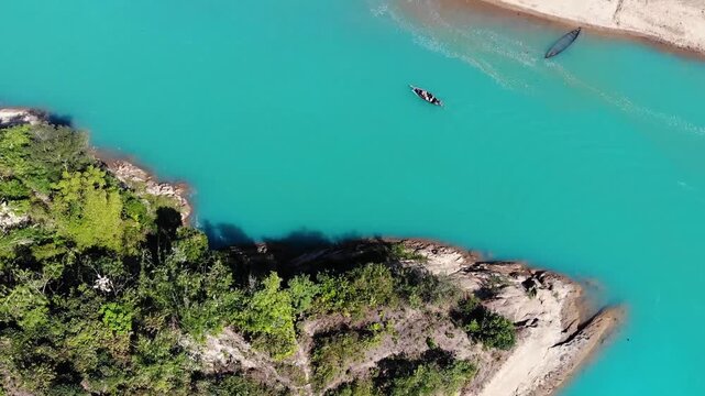 Lala Khal, Bangladesh - 22 August 2025: Aerial view of boats cutting through the turquoise waters, embraced by the lush green forests and sandy riverbanks.
