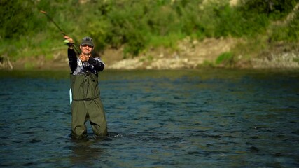 A fisherman casts a spinnerbait on a spinning rod while fishing