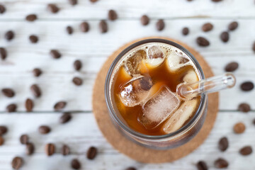 Iced coffee in a glass with a straw. Top view.