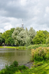 A beautiful landscape picture of a small lake in a park in Amsterdam, Netherlands; with mirror reflection on the water.