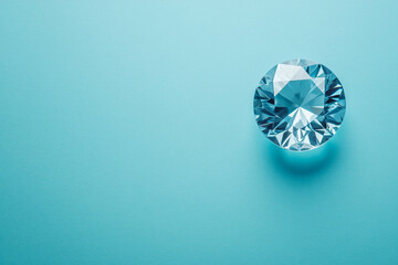Fototapeta premium Sparkling blue gem on a light blue background a beautiful single stone