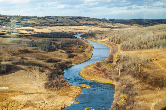 Winding River through a rural prairie landscape between Ontario and British Columbia, Canada