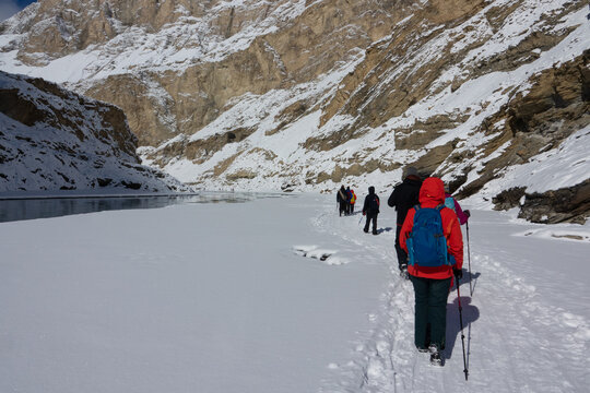 Rear view of people trekking along the Chadar trek by the River Zanskar, Indian Himalayas, Ladakh, India