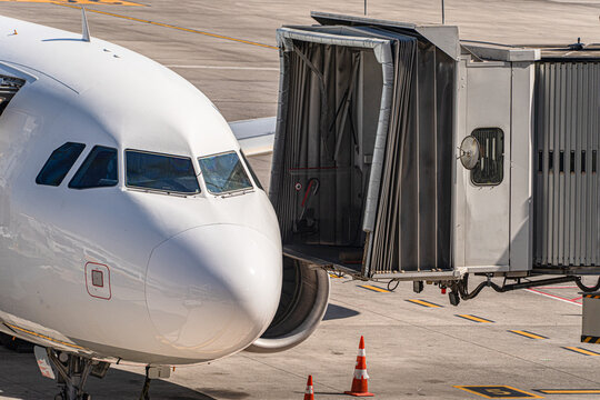 Close-up of an aircraft parked on stand with a jet bridge