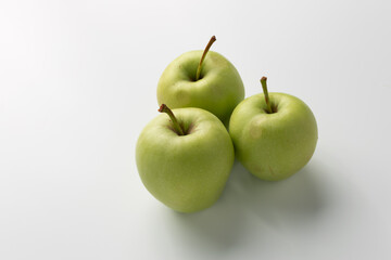 Green apples isolated on a white background, showcasing their ripe and juicy appearance ideal for healthy snacking