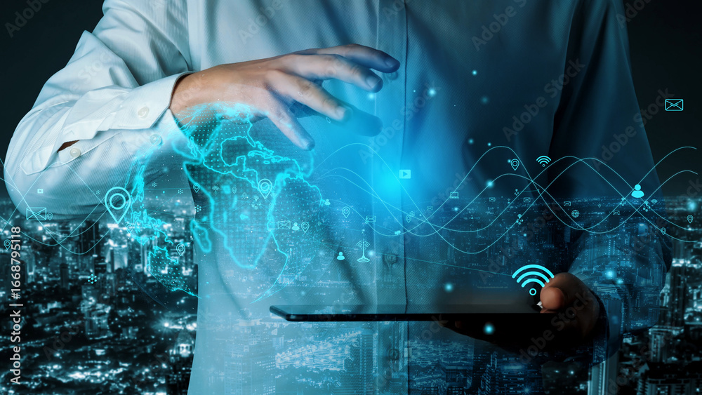 Wall mural a businessman interacts with a digital tablet displaying a holographic world map and wireless connec