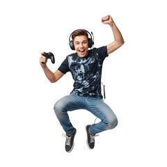 A young man jumping with excitement while holding a game controller and wearing headphones on transparent background