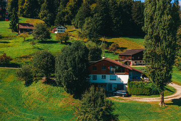 Stunning panoramic view of a cable car ascending Mount Pilatus in the Swiss Alps. The bright red gondola contrasts beautifully with the rugged mountain cliffs, lush green slopes, and distant snow-capp © Breg