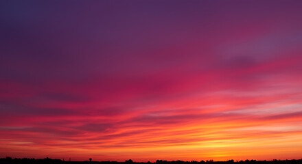 Vibrant magenta sunset sky with orange horizon creates dramatic view.