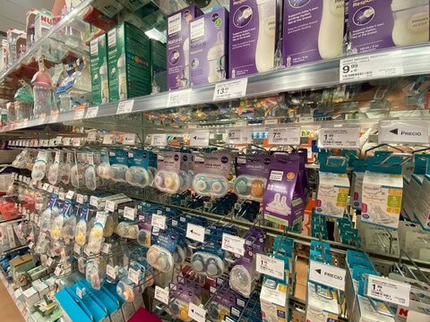 Santa Ponsa, Spain - August 20, 2025: Shelves filled with baby care products and accessories in a retail store, showcasing various brands and items for parents and caregivers