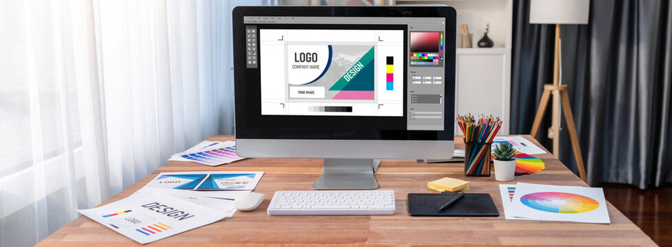 Graphic designer software for modern design of web page and commercial brisk ads showing on the computer screen