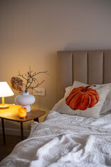 Cozy Autumn Bedroom with a Pumpkin Accent Pillow for an inviting vibe, perfect for relaxation.