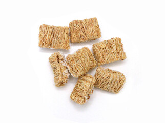 Breakfast setting with frosted wheat cereal on white background