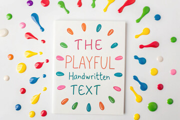 White Card with Handwritten Text Surrounded by Colorful Paint Splatters paper