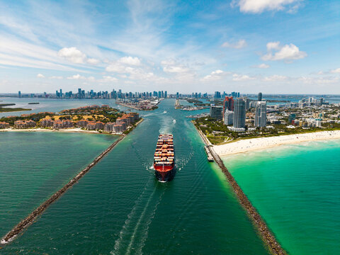 Cargo business. Container ship. Shipping logistics. Commercial shipping. Cargo ship in sea, aerial view. Freight container loaded on cargo vessel. Aerial cargo ship with container. Ship navigation