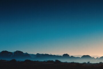 Misty dawn over rolling hills with soft light illuminating the landscape