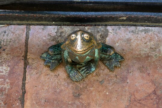 Budapest, Hungary - July 08, 2024: Small bronze figurine of a Muppet Kermit the Frog created by Mihaly Kolodko.