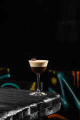 Classic espresso martini alcoholic cocktail with coffee at the dark atmosphere of the bar