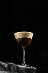 Classic espresso martini alcoholic cocktail with coffee at the dark atmosphere of the bar