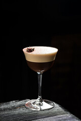 Classic espresso martini alcoholic cocktail with coffee at the dark atmosphere of the bar