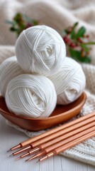 Soft yarn balls and shiny knitting needles are neatly placed on a cozy fabric, inviting a peaceful crafting session on a quiet afternoon