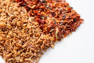 Mix of dried vegetables. Spices red and brown close-up, top view. Dried onion with paprika, tomatoes and olives. Universal seasoning from chopped vegetables