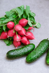 Radish and cucumbers on a gray background. fresh vegetables