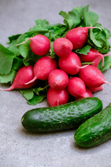 Radish and cucumbers on a gray background. fresh vegetables