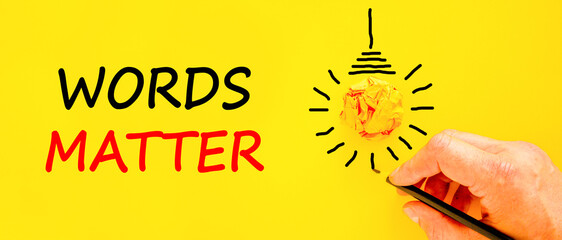 Words matter symbol. Concept word Words matter on beautiful yellow paper. Businessman's hand. Light...