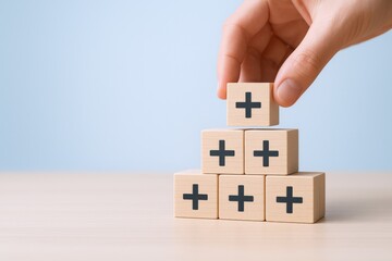 Building Success: Hand Stacking Wooden Blocks with Plus Signs, Symbolizing Growth and Positive Reinforcement