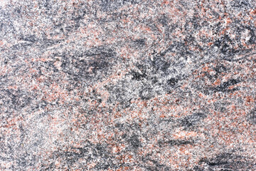 Granite stone texture background. Natural rock surface with black white and pink mineral pattern. Rough granite structure for construction interior design and architecture projects. Closeup detail.
