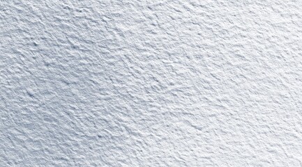 Close-up of a textured, light-blue surface with a slightly grainy, uneven appearance, showing subtle variations in tone and depth