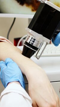 Vertical video. Trichologist conducts close-up examination in medical center. Concept of innovative technology for precise diagnostics of hair and skin health.