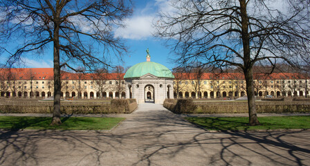 The Diana Temple (Dianatempel) in the Hofgarten, Munich, Germany, framed by bare trees and winter shadows. A symmetrical view of this historic pavilion in the Bavarian capital.