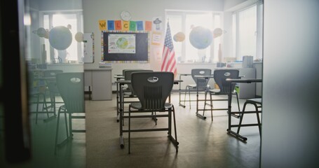 American Primary School: Interior of Modern Empty Classroom with Desks for Students, Chalkboard, Hanging Models of Solar System and Colorful Posters. Creative Space for Children Studying, Education.
