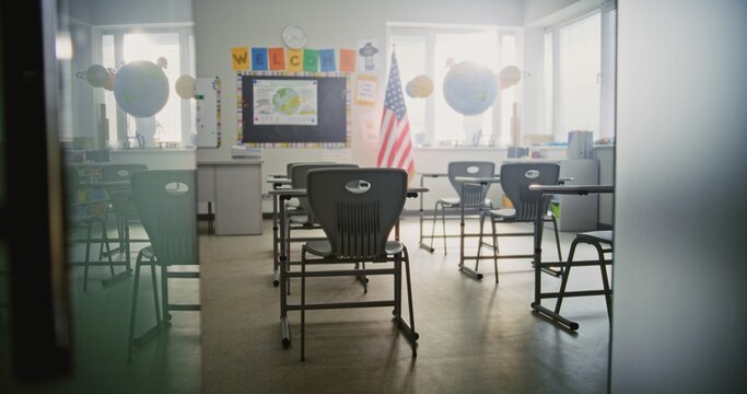 American Primary School: Interior of Modern Empty Classroom with Desks for Students, Chalkboard, Hanging Models of Solar System and Colorful Posters. Creative Space for Children Studying, Education.