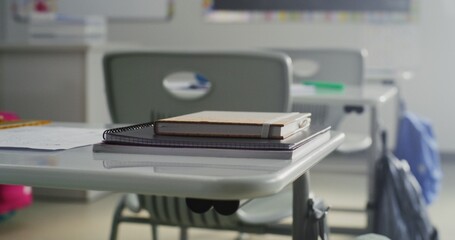 Close Up Shot of Desk for Student, School Supplies and Notebooks for Writing. Interior of Modern Empty Elementary School Classroom, College. Educational and Inspiring Learning Environment for Children