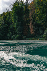 Majestic view of Rhine Falls, the largest waterfall in Europe, located near Schaffhausen in northern Switzerland. Powerful cascades of water rush over rugged rocks, surrounded by lush greenery and mis © Breg