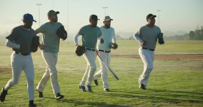 Jogging infield dawn male baseball team greeting senior coach refreshing chalk lines for drill