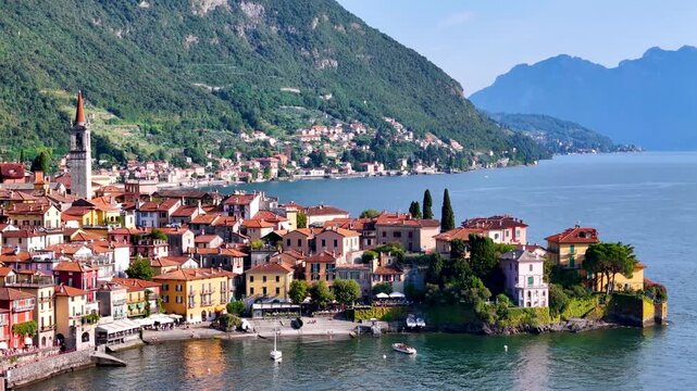 Varenna, Como lake. Picturesque village in Lombardy, Italy. Aerial panoramic 4K drone video footage of beautiful town with colorful houses surrounded by mountains